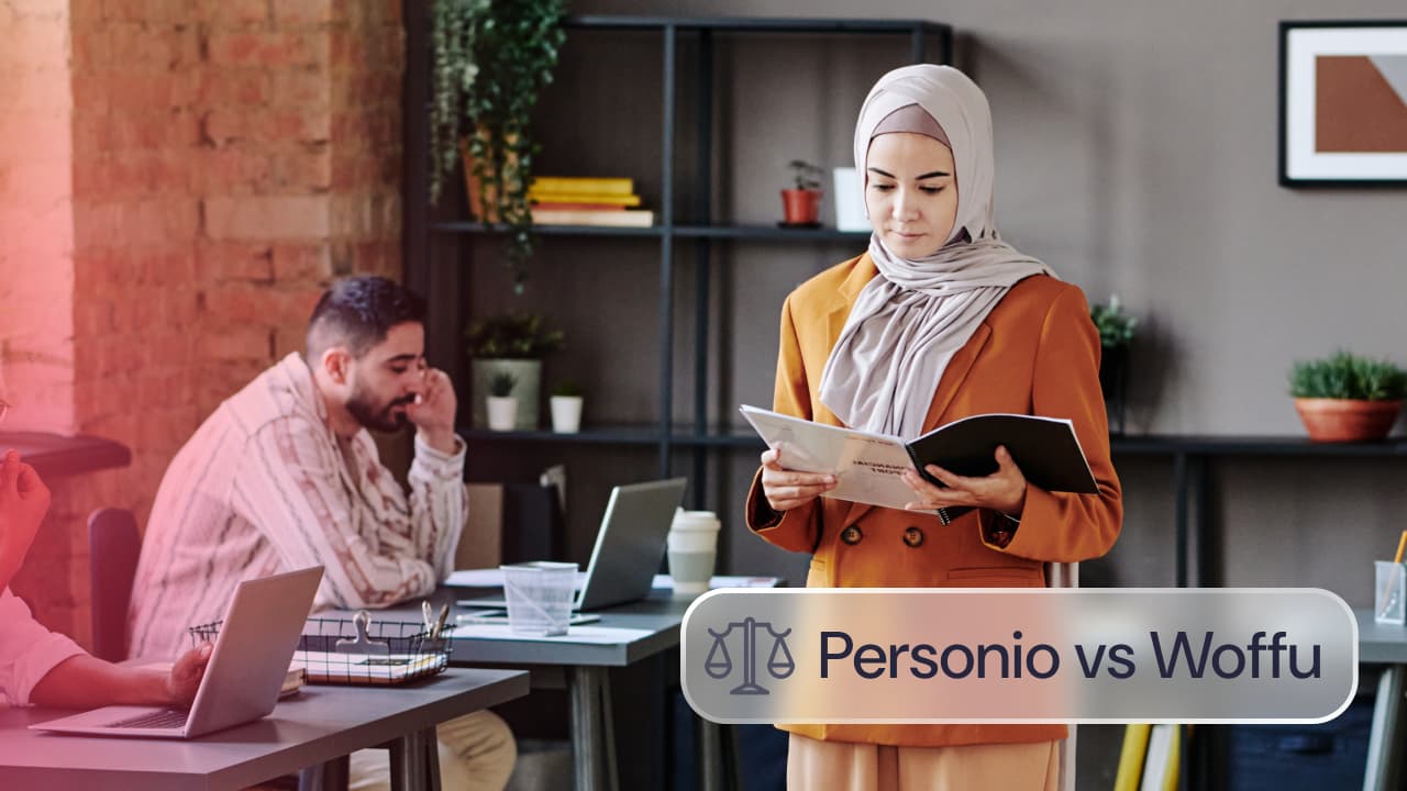 Comparativa Personio vs Woffu: profesionales trabajando en una oficina mientras una compañera revisa documentos y un equipo utiliza portátiles.